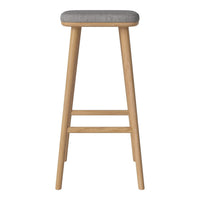 Wooden bar stool with a natural oak finish and a light gray upholstered seat. Simple, modern design.