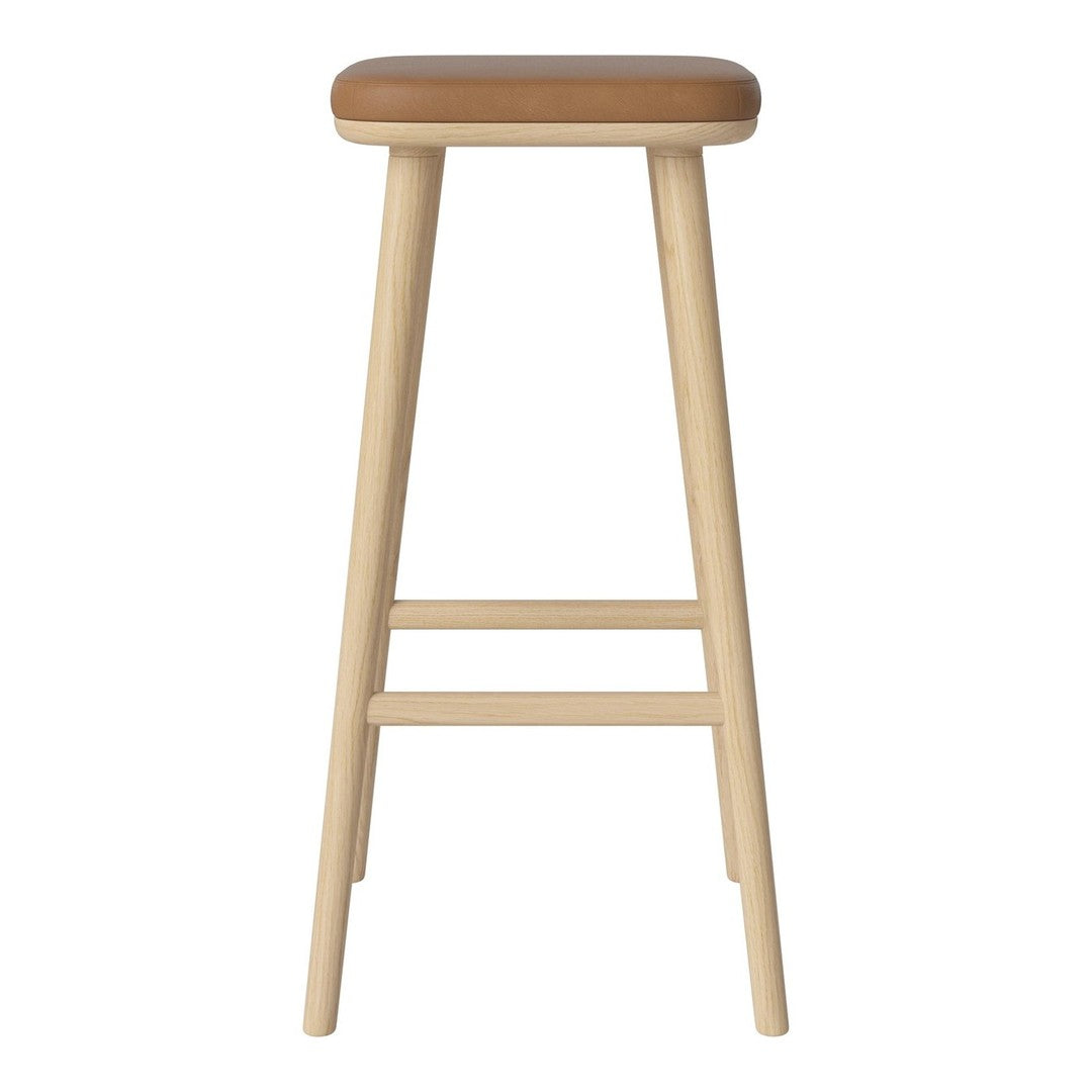 Light wooden bar stool with a tan leather seat, showcasing a simple, modern design.