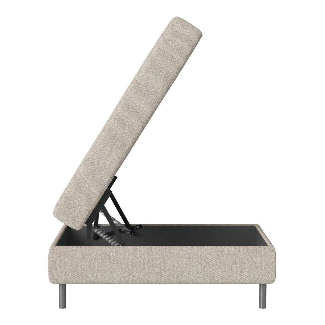 Beige upholstered storage bed with a simple, modern design and sleek black base. Features a lift-top mechanism.