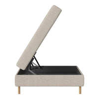 Light beige upholstered storage ottoman with natural wood legs, featuring a sleek, minimalist design.