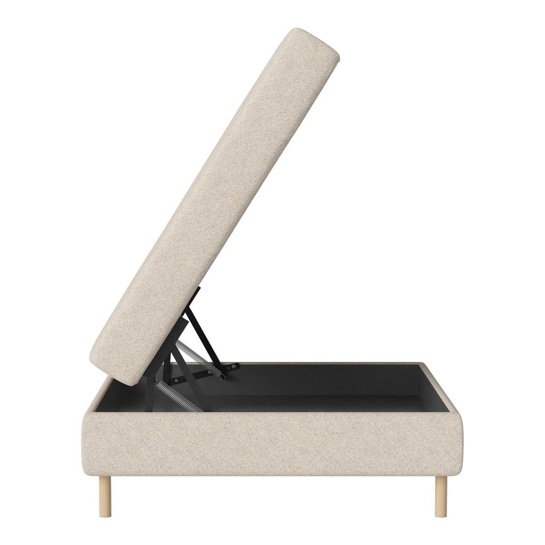 Beige fabric storage bed with natural wood legs and a sleek, minimalistic design. Hinged lid reveals spacious interior.
