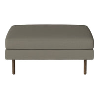 Gray upholstered ottoman with a smooth texture and minimalist design, featuring wooden legs. Perfect for modern decor.