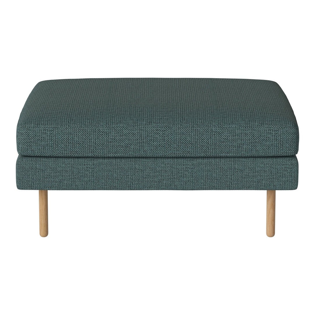 Teal upholstered ottoman with a textured fabric and light wooden legs. Ideal for modern and cozy interiors.