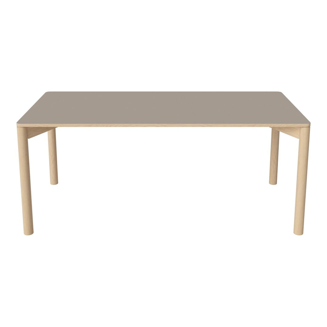Light wood dining table with a smooth, taupe-colored top and minimalistic design. Perfect for modern interiors.