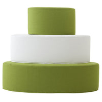 "Modern stacked cushions in vibrant green and sleek white with smooth, minimalist patterns."