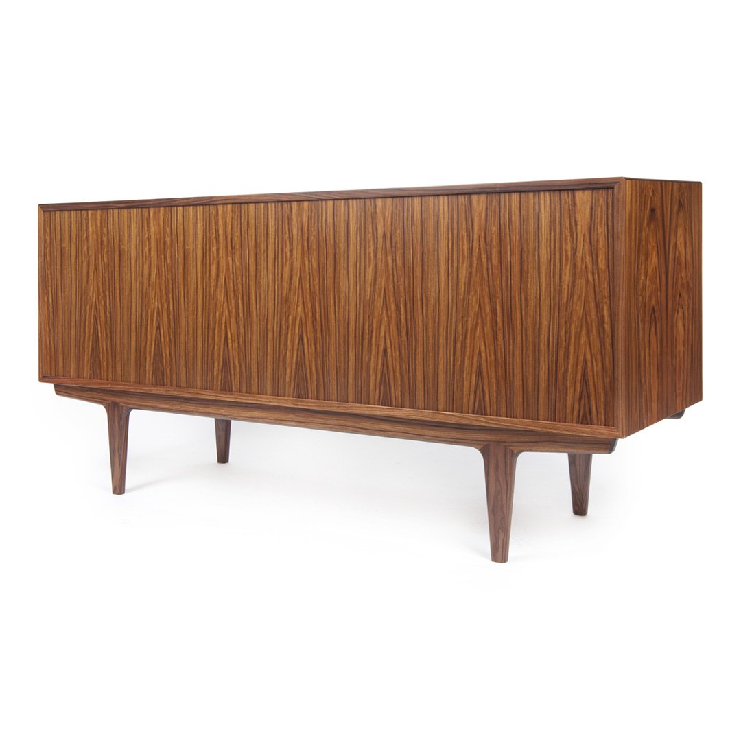 Mid-century modern sideboard in rich walnut finish with vertical grain pattern and tapered wooden legs.