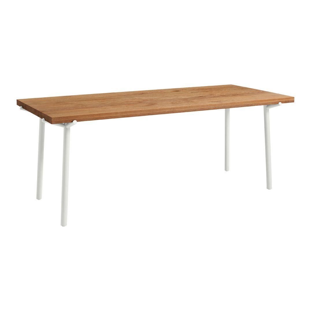 Brown wood table top with a sleek, natural finish, supported by modern white metal legs. Simple and elegant design.