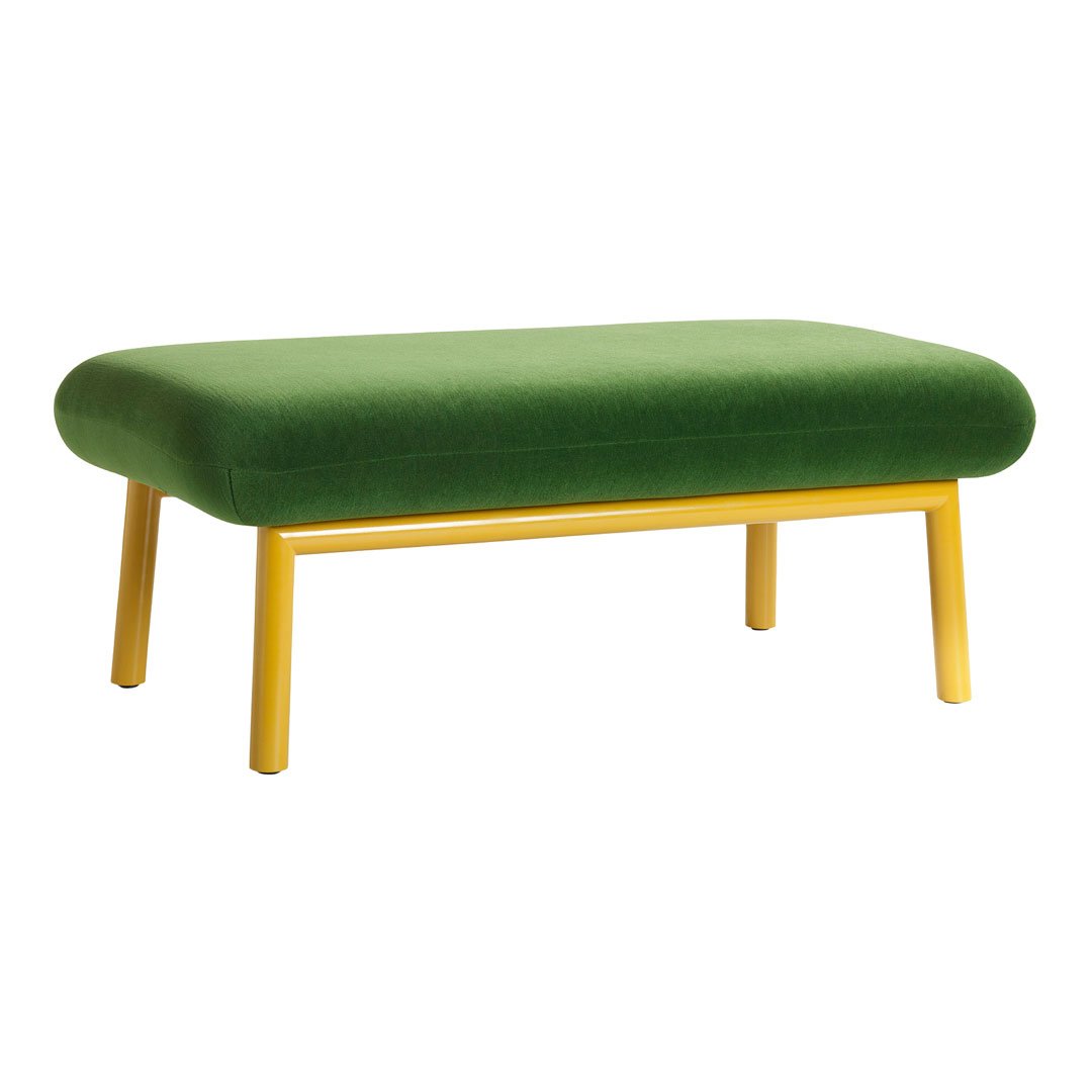 Green velvet ottoman with yellow legs, featuring a smooth, modern design. Perfect for vibrant decor.