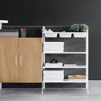 White shelving unit with natural wood cabinet, gray backdrop, and clean lines. Organizes with minimalistic style.