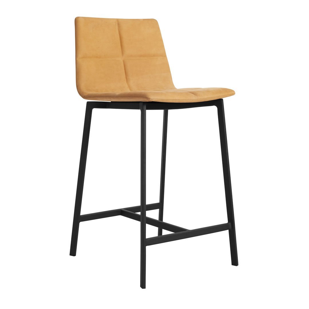 Tan upholstered bar stool with quilted pattern and sleek black metal legs. Ideal for modern decor.
