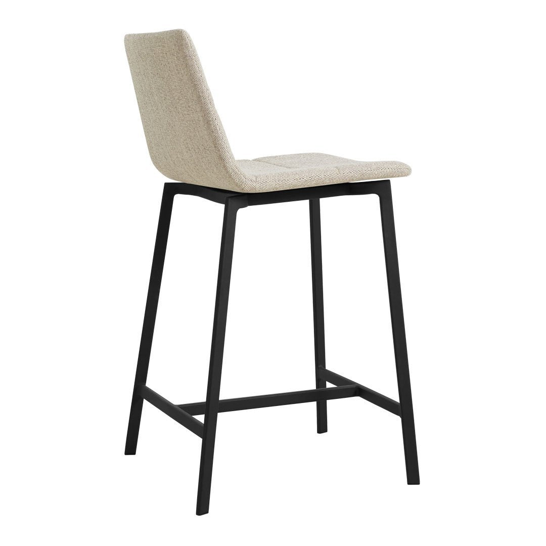 Beige upholstered bar stool with textured fabric and sleek black metal legs. Perfect for modern interiors.