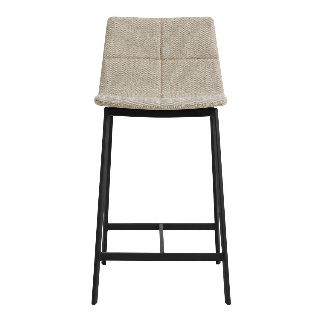 Beige upholstered bar stool with a quilted pattern and sleek black metal frame. Modern neutral color palette.
