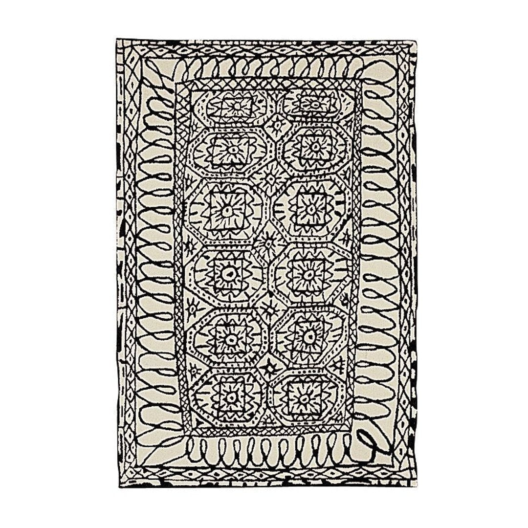 Black and cream geometric patterned rug featuring intricate designs and flowing lines. Perfect for stylish decor.