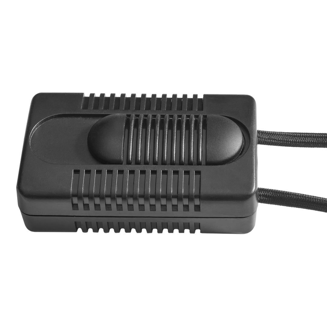 Black rectangular device with ridged surface and a smooth center button, featuring two attached black cords.