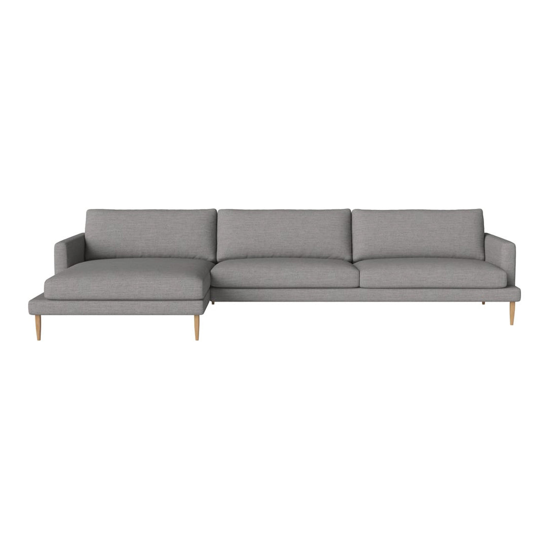 Gray sectional sofa with clean lines and minimalist design, featuring plump cushions and wooden legs.