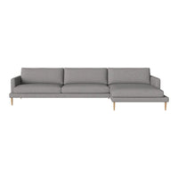 Modern gray sectional sofa with clean lines and a minimalist design, featuring a solid color upholstery and light wood legs.