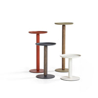 Four modern side tables featuring red, olive green, black, and white finishes with sleek circular tops.