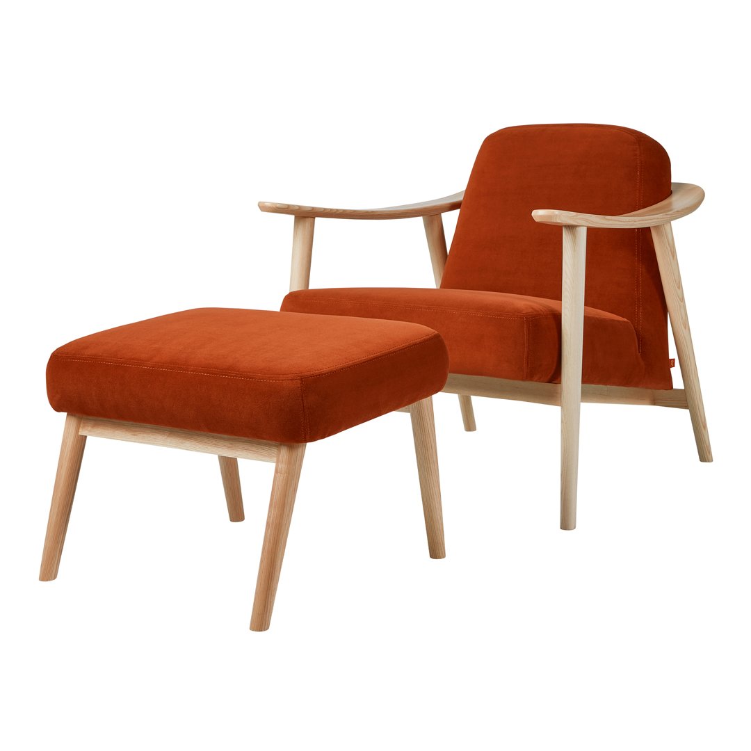 Rust orange velvet armchair and ottoman with natural wood legs, minimalistic design and smooth, soft textures.