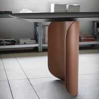 Modern desk featuring a sleek black top and a curved brown metal base, creating a stylish contrast.