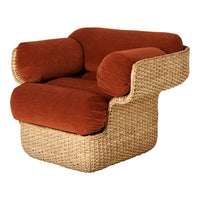 Rust-colored cushions on a woven natural rattan frame, featuring a modern, curved design. Perfect for stylish decor.
