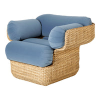 Cozy light blue cushion armchair with textured woven rattan base, perfect for stylish interior decor.