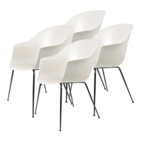 Set of four modern white chairs with smooth curves and sleek black metal legs. Ideal for minimalist decor.