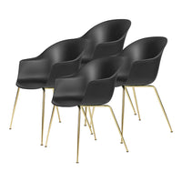 Set of four sleek black chairs with smooth curves and gold metal legs, perfect for modern decor.