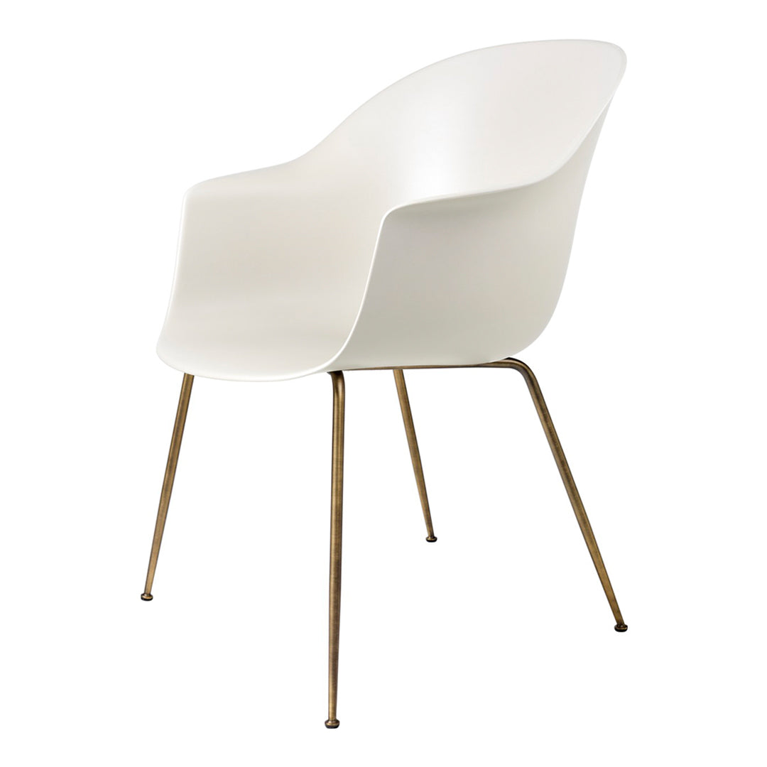 Stylish white chair with smooth curved design and sleek gold metal legs, perfect for modern decor.