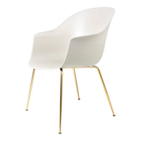 White chair with sleek lines and gold legs, featuring a minimalistic design ideal for modern decor.