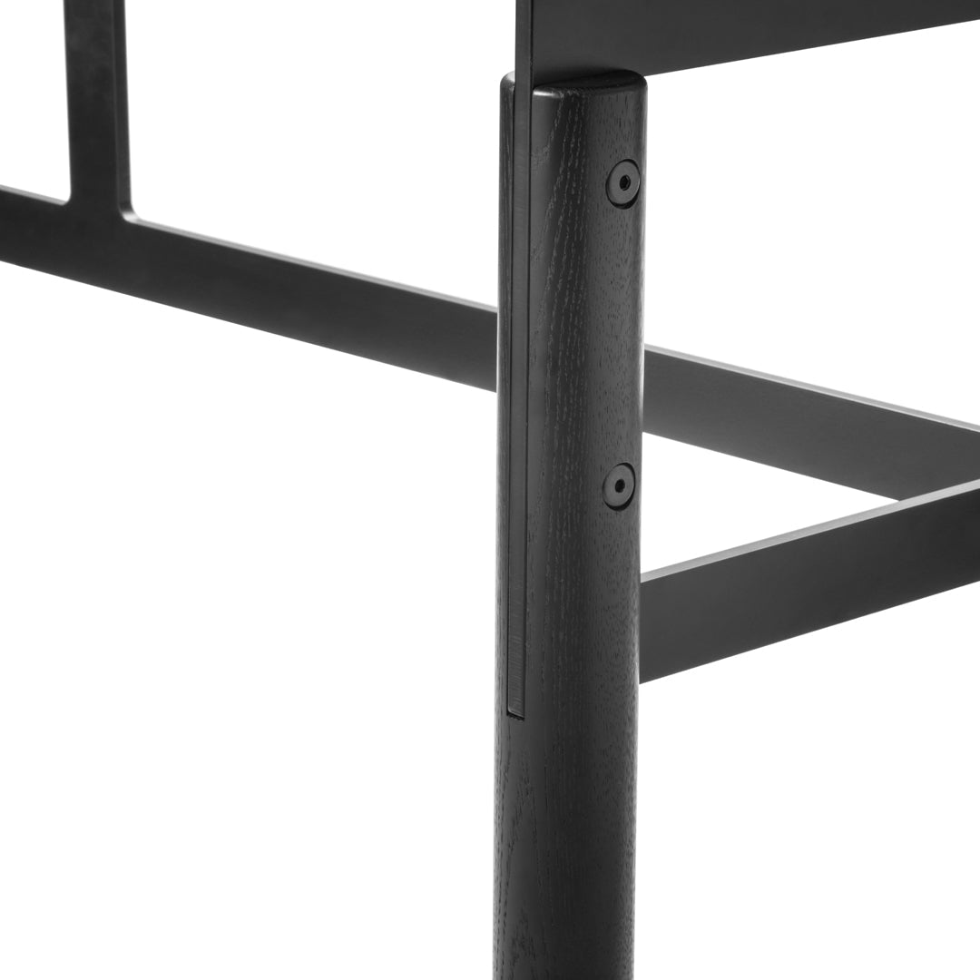 Black metal chair leg with a textured finish, showcasing sleek lines and minimalist design.