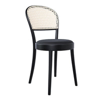 Black chair with a rattan backrest featuring a white woven pattern. Chic and modern design for any space.