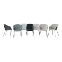 Set of eight modern chairs in shades of gray, green, and white with sleek metal legs, showcasing various textures and patterns.