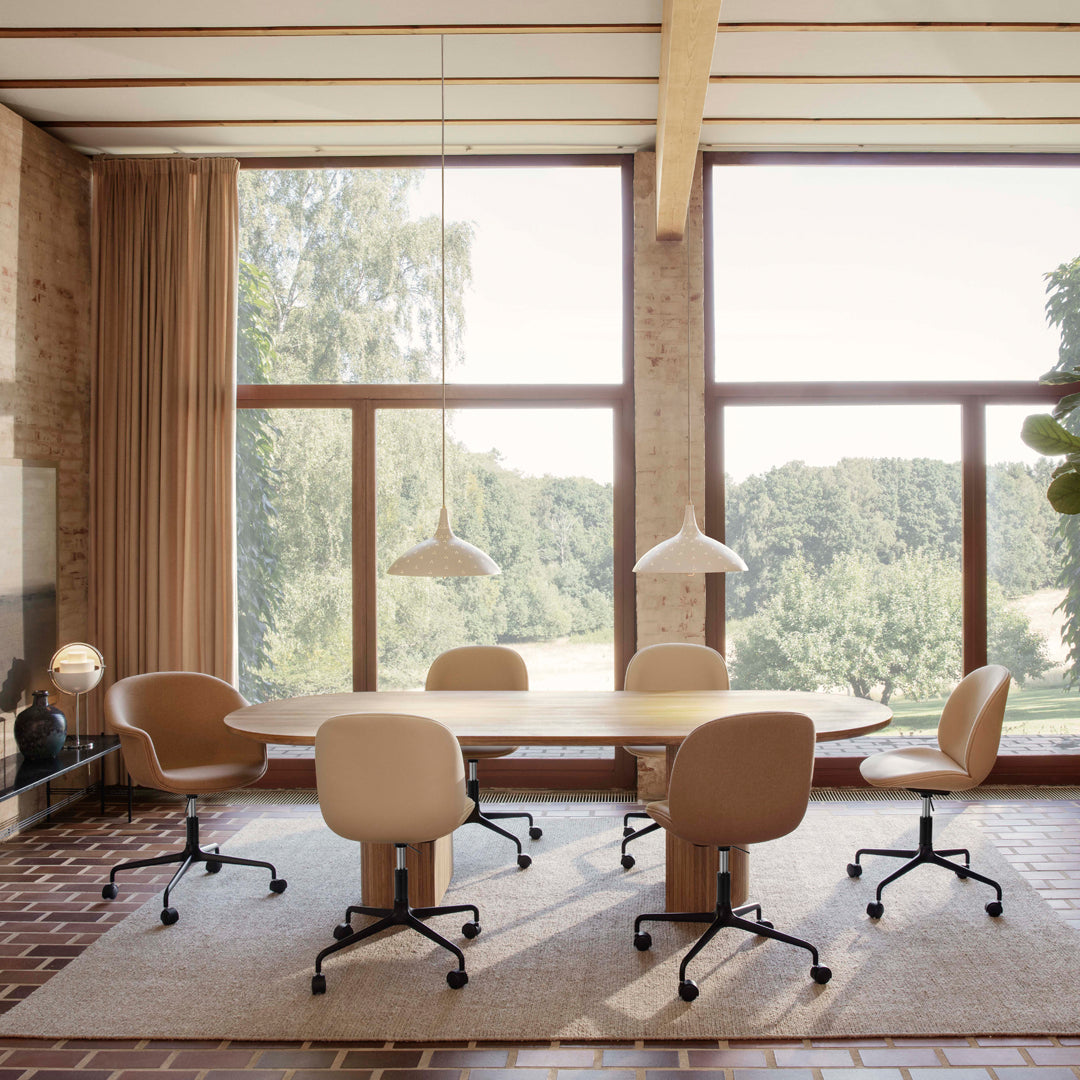 "Light beige ergonomic office chairs in a sunlit room with neutral tones and natural wood accents."