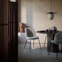Modern gray chairs with soft textures and minimalist designs, set against neutral walls and rich wooden accents.