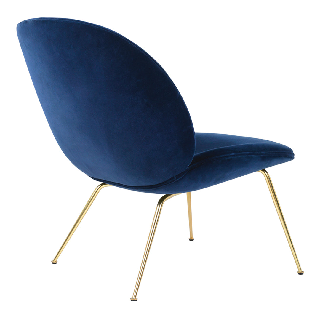 Navy blue velvet chair with gold metal legs, featuring a sleek, modern design and a smooth, textured surface.