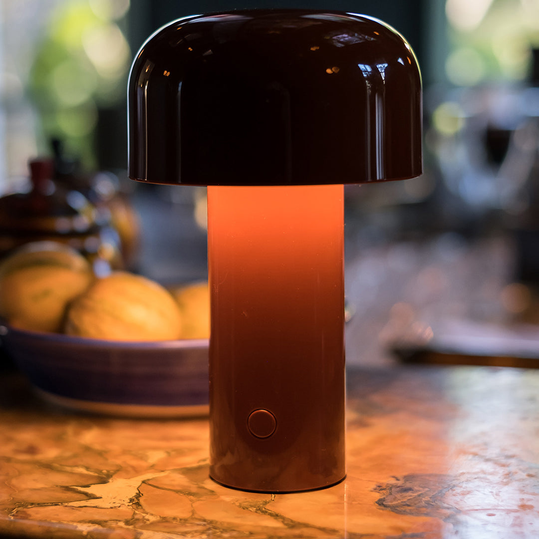 Brown and orange gradient lamp with a glossy dome shape and sleek cylindrical base. Perfect for modern decor.