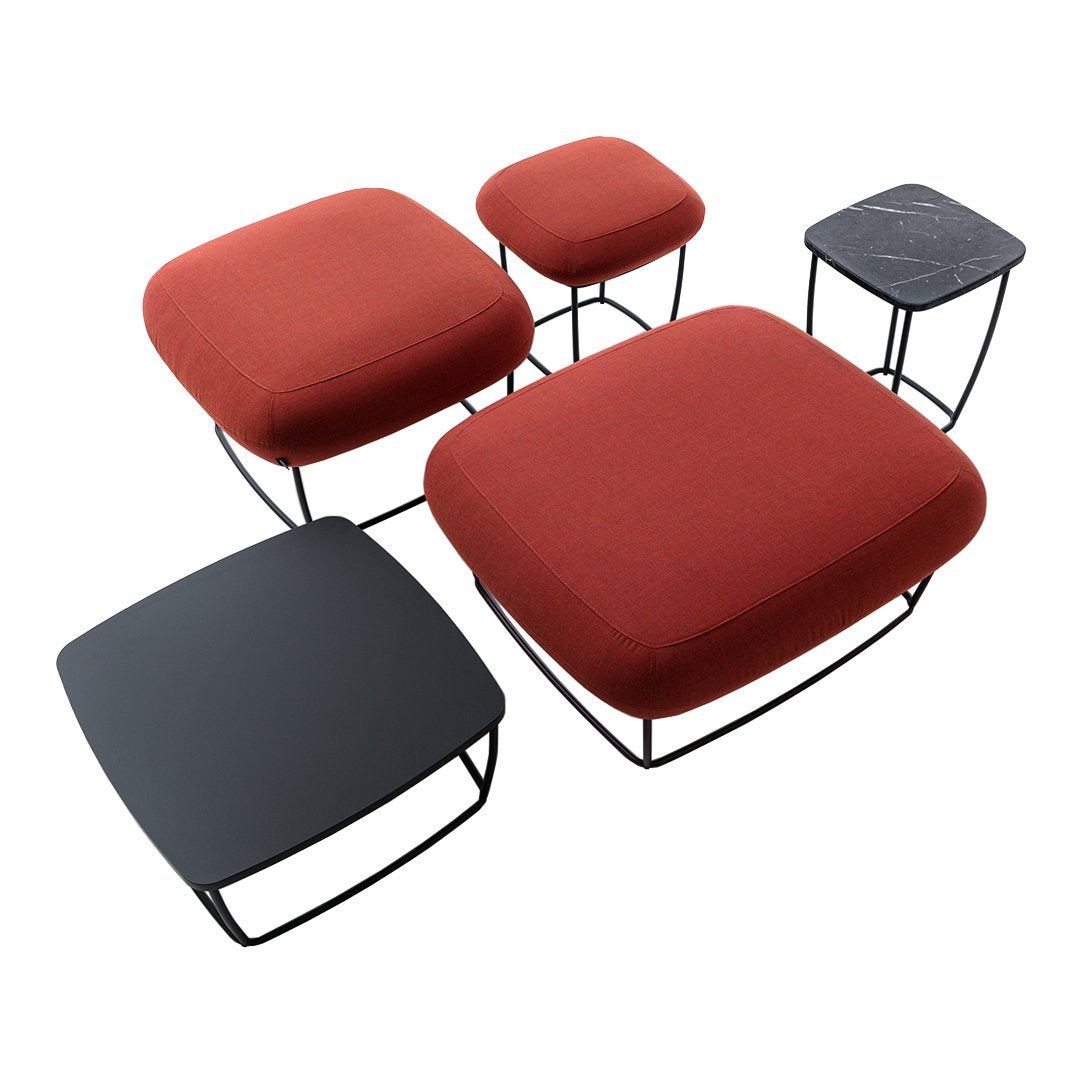 "Set of five modern cushions in rich red and sleek black, featuring various geometric designs."