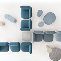 Soft blue upholstered chairs and light gray accent tables on a white background. Modern, minimalist design.