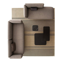 Gray upholstered sofas on a beige and gray striped rug with black accent tables. Modern, minimalistic design.