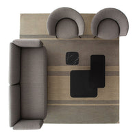 Gray sofa and chairs on a striped beige and gray rug, featuring black accent tables for a modern look.