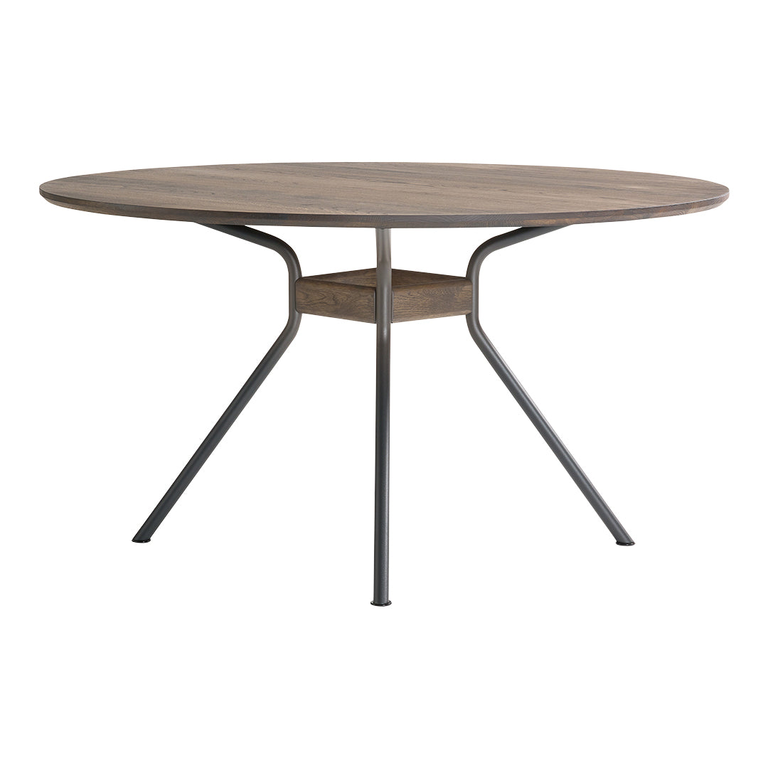 Round wooden dining table with a light brown finish and black metal legs, featuring a sleek, modern design.
