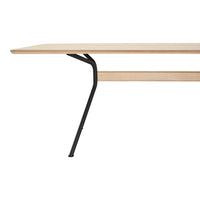 Light wood tabletop with a smooth finish and minimalistic black metal legs. Modern design with a natural aesthetic.