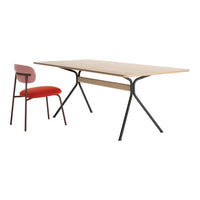 Modern wooden table with light natural finish and black metal legs, paired with a pink and red chair.