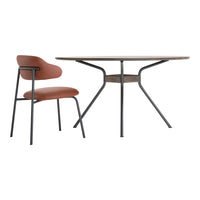 Brown wooden table with a smooth surface and a black metal base, accompanied by a rust-colored chair with a minimalist design.