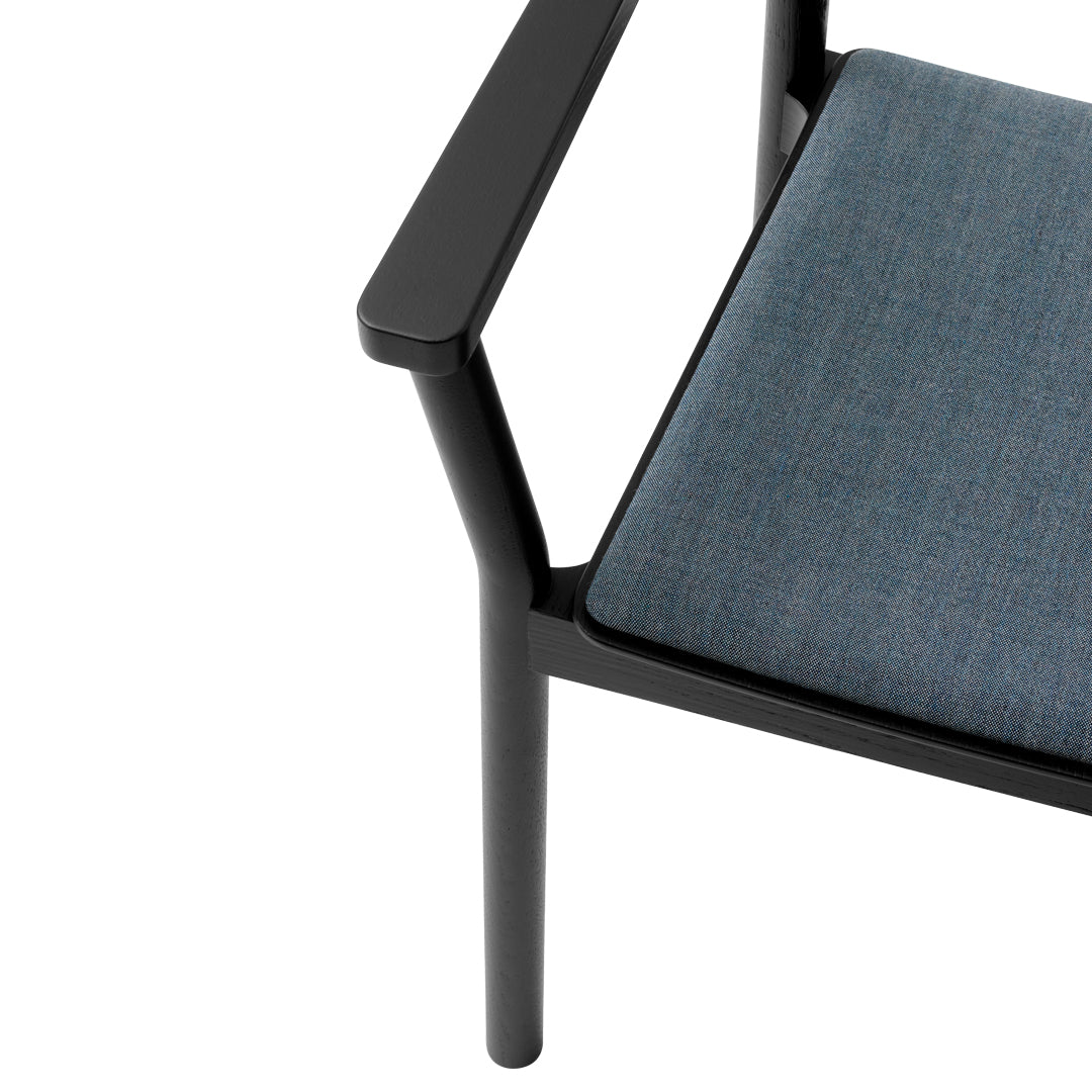 Black frame chair with a sleek, dark denim blue cushion providing a modern, stylish contrast.