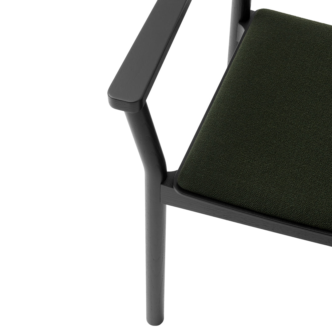 Black-framed chair with a rich green cushion, featuring a sleek and modern design.