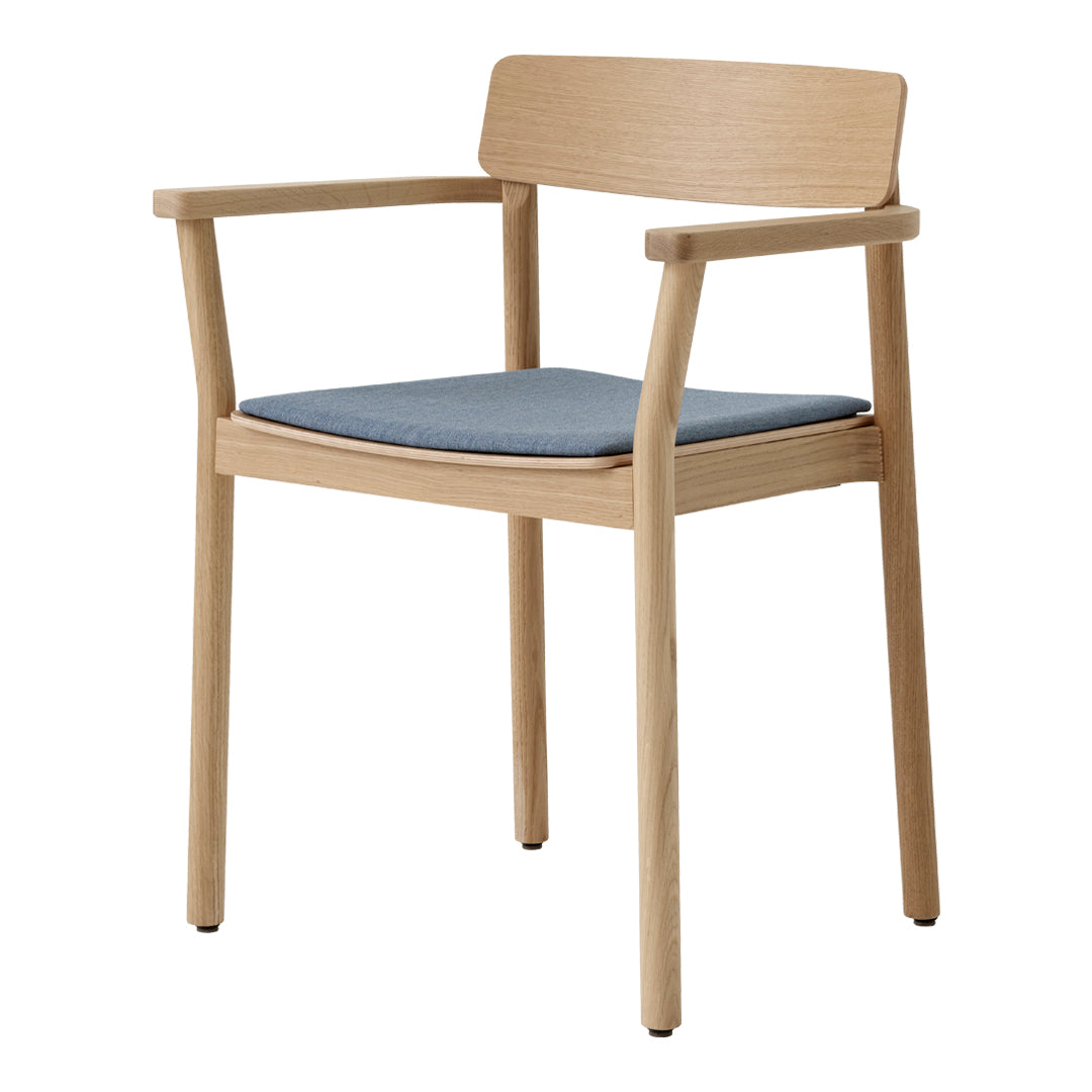 Light wood armchair with a blue upholstered seat, featuring a minimalist design and natural finish.