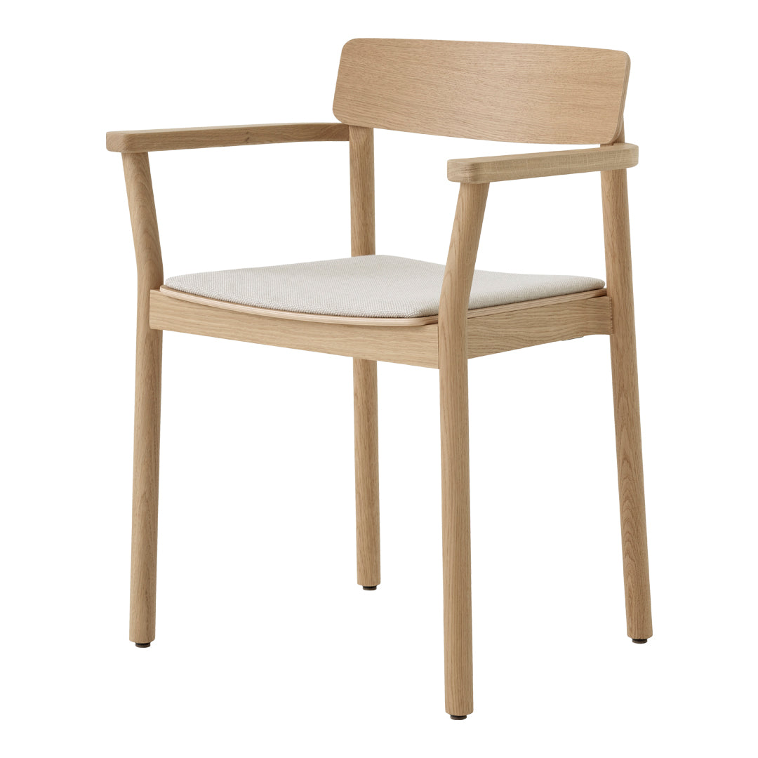 Light wooden chair with a natural finish and an off-white padded seat, showcasing a minimalist design.