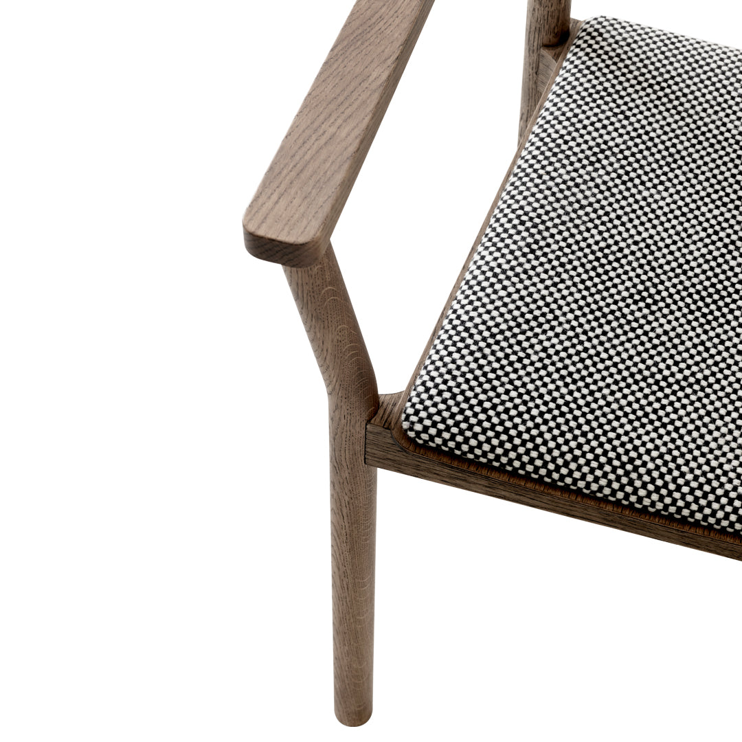 Grey wooden chair with a black and white houndstooth patterned cushion. Modern and stylish design for any space.
