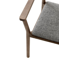 Grey wooden chair with a black and white houndstooth patterned cushion. Modern and stylish design for any space.